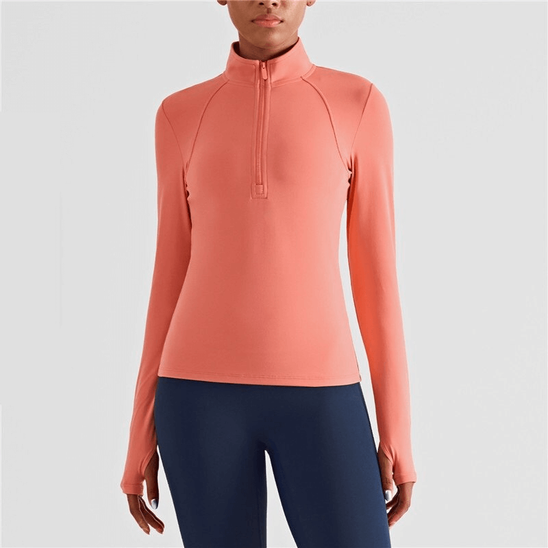 Women's elastic long sleeve fitness sweatshirt with finger cut-out, anti-pilling, and quick-dry technology, in peach color.